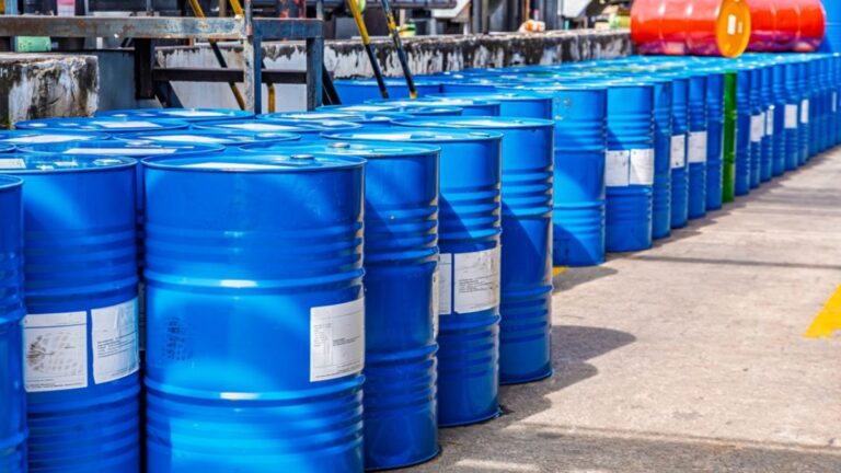 Blue industrial chemical drums at hazardous waste facility demonstrating RCRA empty container requirements and compliance standards