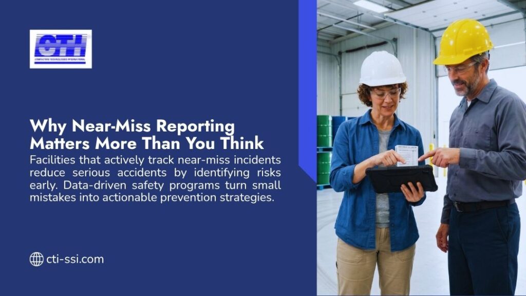 Two safety officers in hard hats reviewing incident data on a tablet in an industrial facility, highlighting the importance of near-miss reporting in workplace safety.